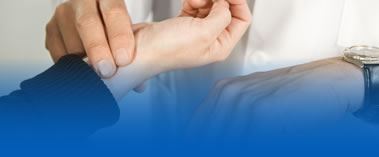 Clinician taking a patient's pulse