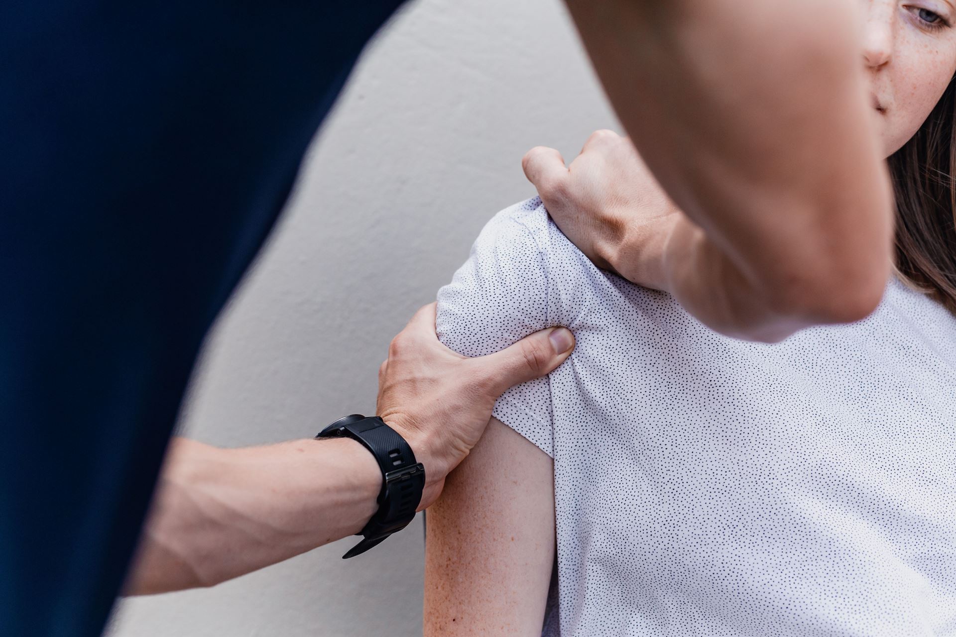 a physiotherapist working on a man's shoulder