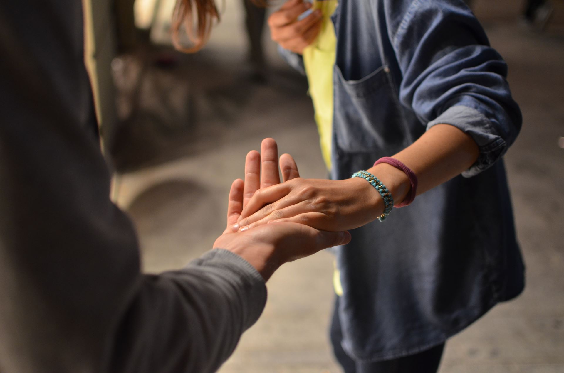 a young woman reaching out to provide a helping hand to a man