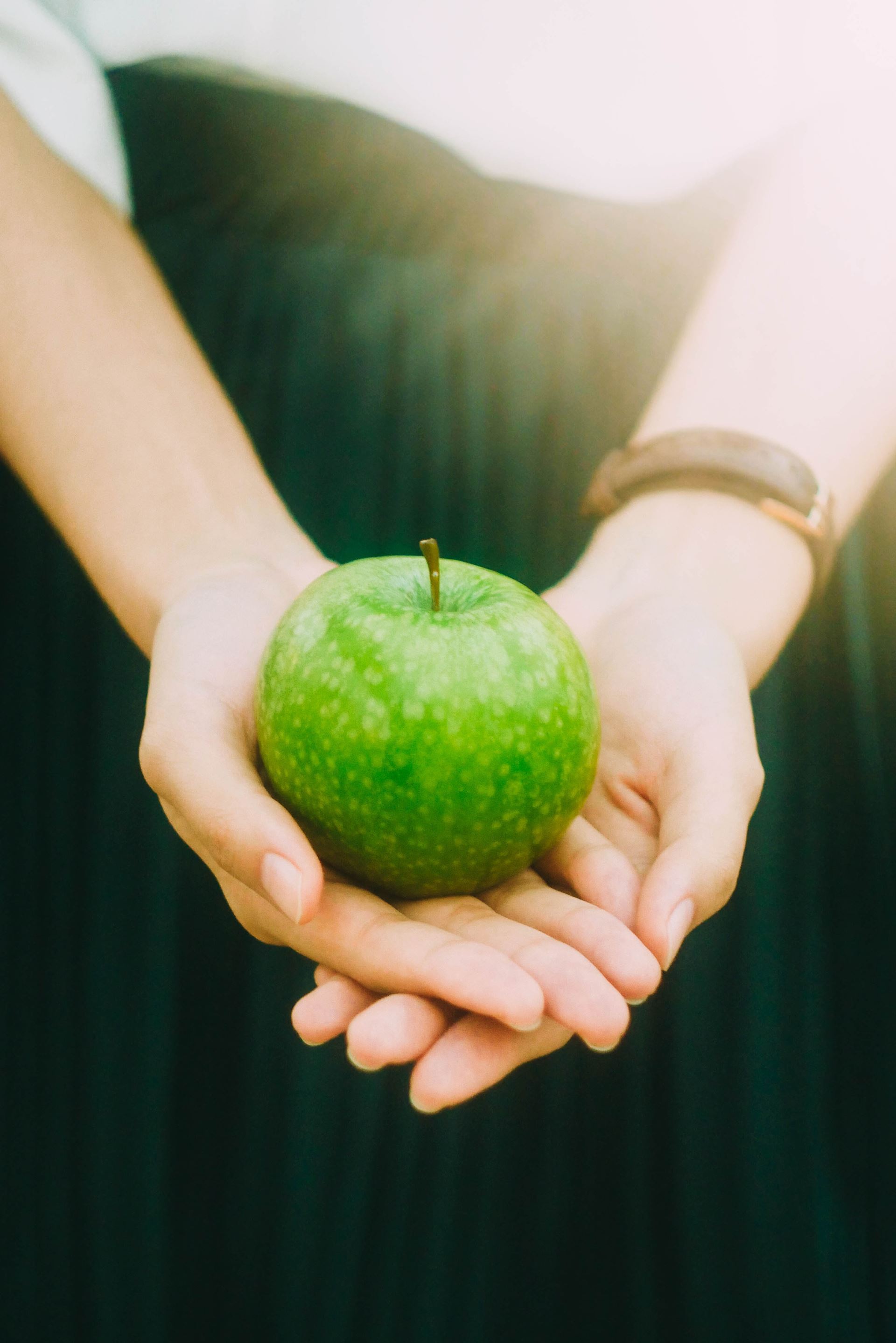 a person holding an apple