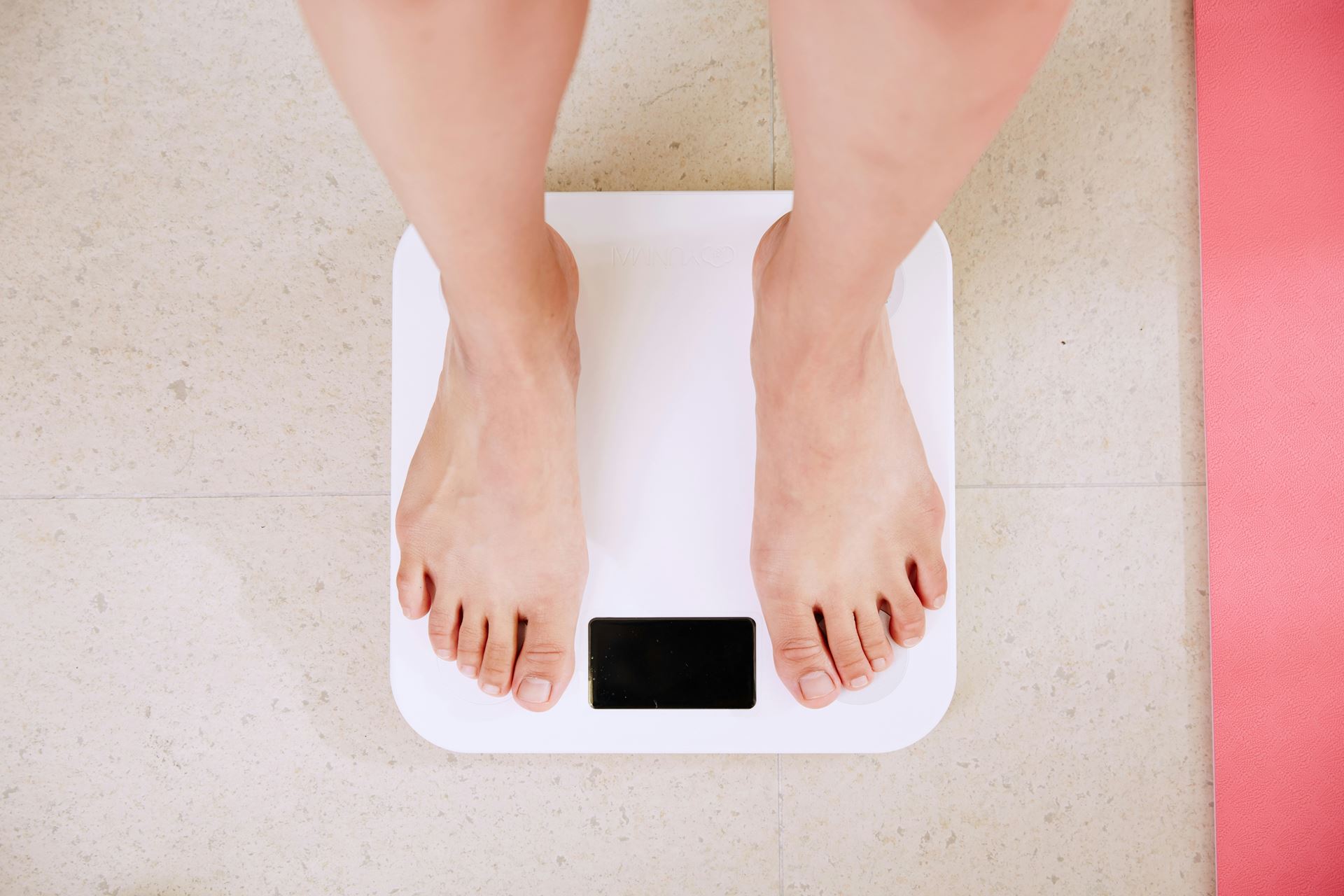 a pair of feed of a person stood on weighing scales