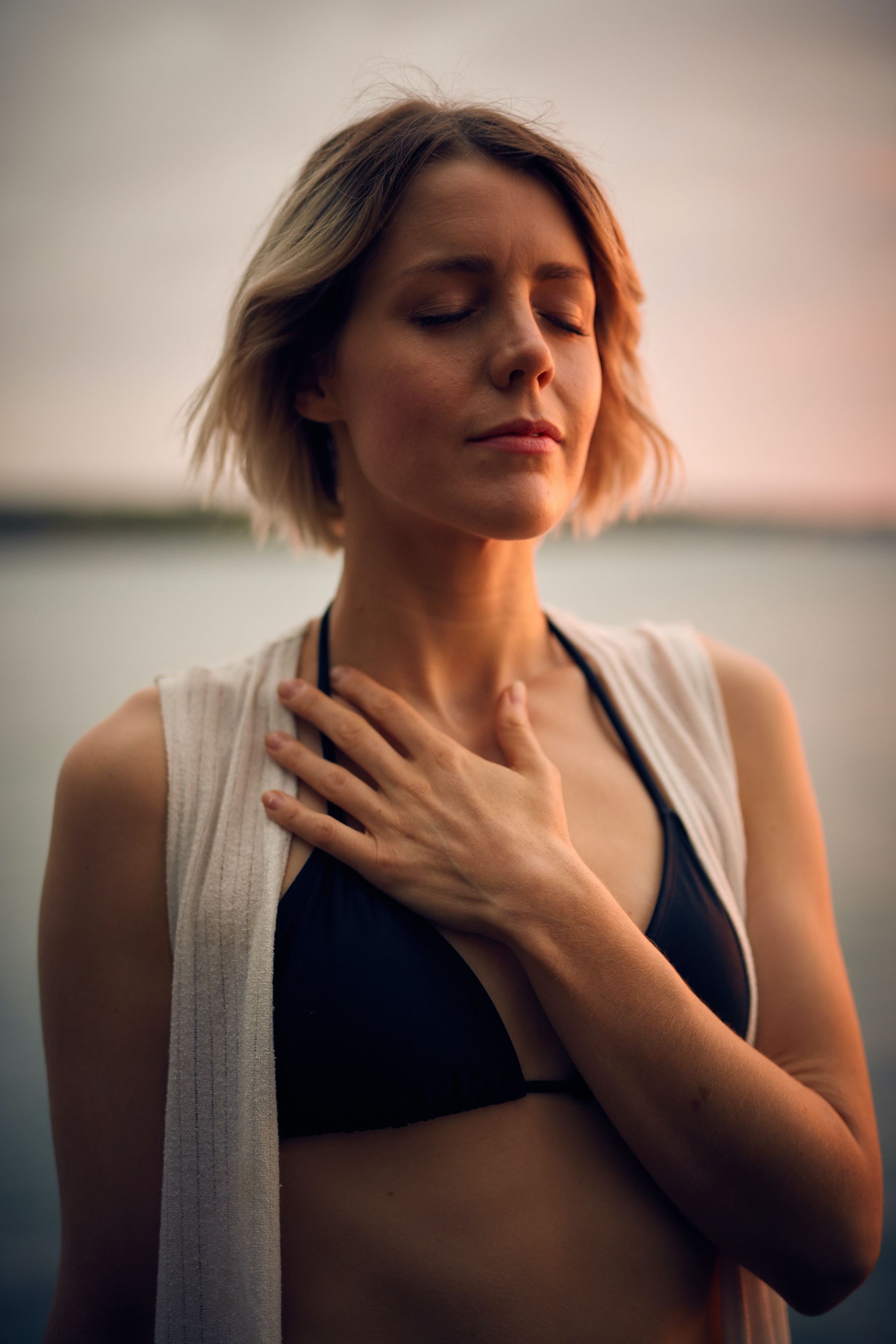 a woman holding her hand on her chest
